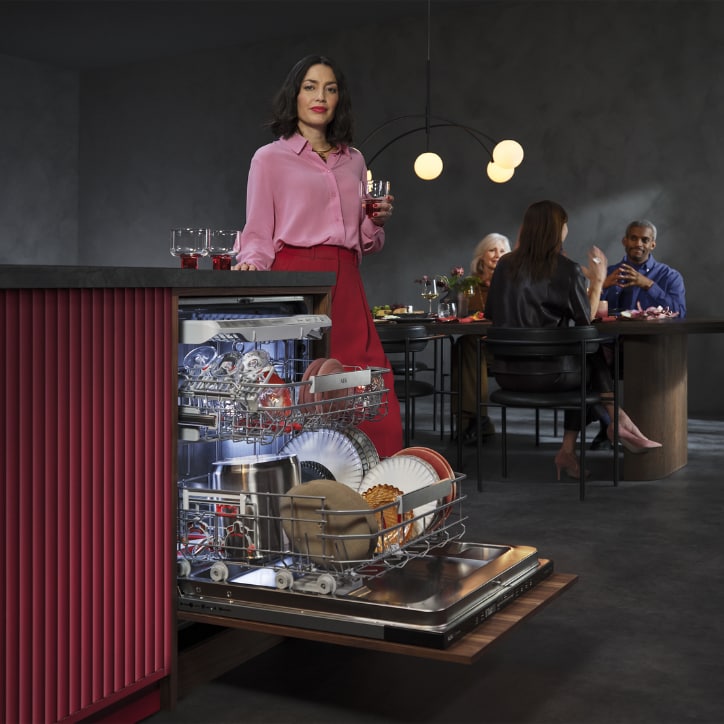Woman unloading dishwasher