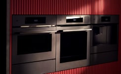 Man holding flowers in front of oven