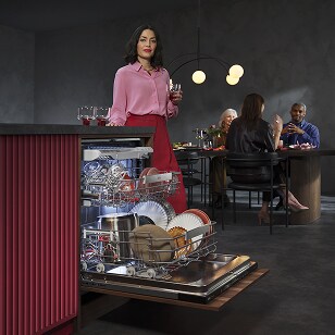 Woman unloading dishwasher